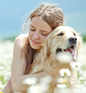 Woman Hugging dog with flowers
